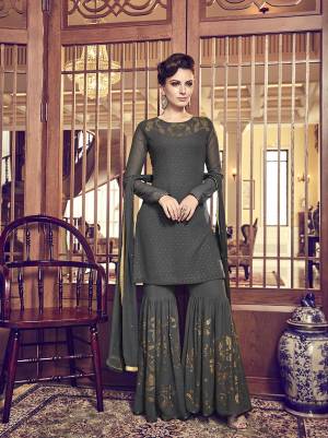 Flaunt Your Rich And Elegant Taste Wearing This Designer Sharara Suit In Dark Grey Color. Its Top, Bottom And Dupatta Are Fabricated On Georgette Based Beautified With Attractive Stone Work All Over It. Buy This Semi-Stitched Suit Now.