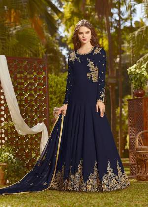 Eye Catchy And Trendy Color Is Here With This Designer Floor Length Suit In Navy Blue Color Paired With Navy Blue Colored Bottom And Dupatta. Its Top And Dupatta Are Fabricated On Georgette Paired With Santoon Bottom. It Is Beautified With Attractive Embroidery. Buy Now.