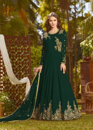 Eye Catchy And Trendy Color Is Here With This Designer Floor Length Suit In Dark Green Color Paired With Dark Green Colored Bottom And Dupatta. Its Top And Dupatta Are Fabricated On Georgette Paired With Santoon Bottom. It Is Beautified With Attractive Embroidery. Buy Now.