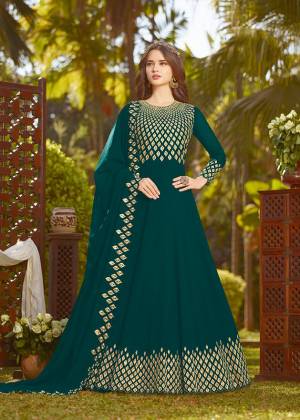 Enhance Your Personality Wearing This Heavy Designer Floor Length Suit In Rich Teal Blue Color Paired With Teal Blue Colored Bottom And Dupatta. It Top And Dupatta Are Georgette Fabricated Beautified With Heavy Embroidery Paired With Santoon Fabricated Bottom. Buy This Semi-Stitched Suit Now.
