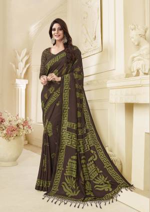 Enhance Your Personality Wearing This Lovely Saree In Brown Color Paired With Brown Colored Blouse. This Saree And Blouse Are Silk Beautified With Contrasting Green Colored Prints All Over It. 