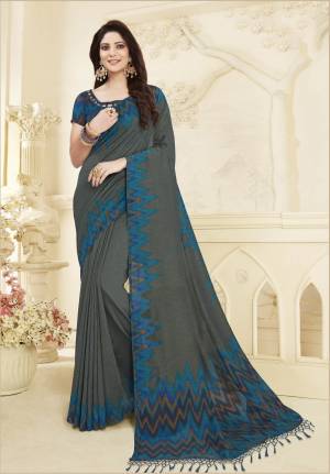 Flaunt Your Rich And Elegant Taste Wearing This Designer Printed Saree In Dark Grey Color Paired With Contrasting Blue Colored Blouse. This Saree And Blouse Are Fabricated On Art Silk Beautified Ikkat Type Print. 