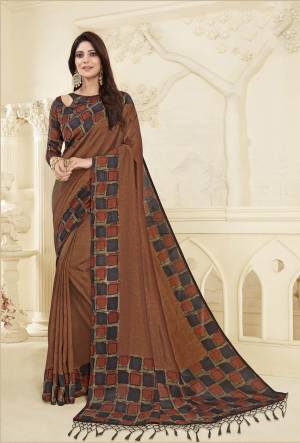 This Festive Season Wear This Rich And elegant Looking Printed Saree In Brown Color Paired With Multi Colored Blouse. This Saree And Blouse are Fabricated On Art Silk Beautified With Checks Prints Over The Blouse And Saree Border. 