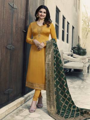 Celebrate This Festive Season With Beauty And Comfort Wearing This Designer Straight Cut Suit In Musturd Yellow Color Paired With Contrasting Dark Green Colored Dupatta. Its Top Is Satin Georgette Based Beautified With Embroidery Paired With Santoon Bottom And Banarasi Art Silk Dupatta.  Buy Now.