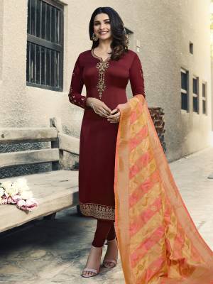Here Is A Royal Looking Designer Straight Suit In Maroon Color Paired With Contrasting Yellow And Peach Colored Dupatta. Its Top Is Fabricated On Satin Georgette Paired With Santoon Bottom And Banarasi Art Silk Dupatta. All Its Fabrics Are Light Weight And Easy To Carry All Day Long. 