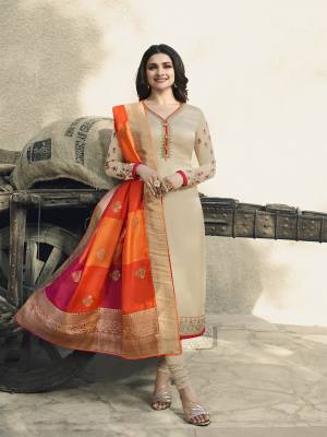 Flaunt Your Rich And Elegant Taste Wearing This Designer Straight Cut Suit In Cream Color Paired With Orange Colored Dupatta. It Is Satin Georgette Based Paired With Santoon Bottom And Silk Based Dupatta. 