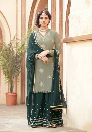 Go With These Beautiful Shades Of Green With This Designer Sharara Suit In Pastel Green Colored Top Paired With Pine Green Colored Bottom And Dupatta. Its Embroidered Top And Bottom Are Fabricated On Georgette Paired With Chiffon Fabricated Dupatta. Buy This Now.