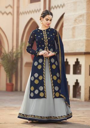 This Festive And Wedding Season, Adorn A Whole New Look With This Designer Indo-Western Pair In Navy Blue Colored Top And Dupatta Paired With Contrasting Grey Colored Bottom. Its Top And Bottom Are Georgette Based Paired With Chiffon Dupatta. Its Fabrics Are Light In Weight Which Ensures A Superb Comfort. 