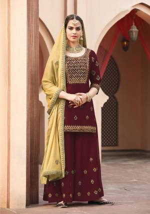 Celebrate This Festive With Beauty And Comfort With This Designer And Royal looking Sharara Suit In Maroon Color Paired With Contrasting Yellow Colored Dupatta. Its Top And bottom Are Georgette Based Paired With Chiffon Fabricated Dupatta. 