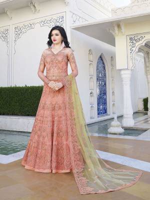 Look Pretty In This Designer Floor Length Suit In Dark Peach Color Paired With Contrasting Pastel Green Colored Dupatta. Its Heavy Embroidered Top Is Fabricated On Net Paired With Satin Bottom And Net Fabricated Dupatta. Buy Now.
