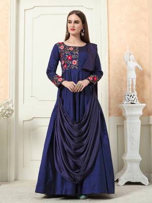 Grab This Beautiful Designer Readymade Gown In Navy Blue Color For The Upcoming Festive And Wedding Season. This Pretty Gown Is Fabricated On Tafeta Art Silk Beautified With A Drape Pattern And Attractive Embroidery Work. 