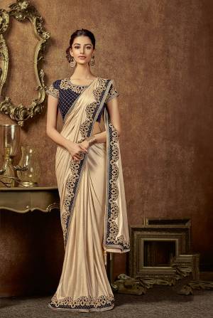 Be a glamourous trendsetter with a touch of classic to your look in this subtle yet stylish pre-draped saree. 