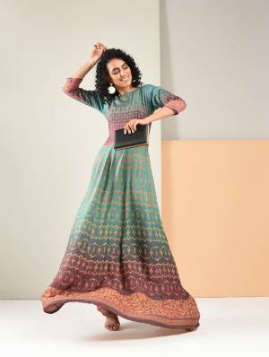 Unique Color Pallete Is Here With This Readymade Gown In Blue And Purple Color. It Is Fabricated On Rayon Beautified With Pretty Prints All Over. 