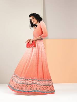 Grab This Designer Readymade Gown In Dark Peach Color Fabricated On Rayon. This Pretty Gown Is Beautified With Prints And Also It Is Light In Weight And Easy To Carry All Day Long. 