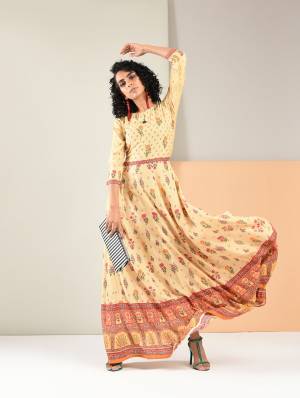 Flaunt Your Rich And Elegant Taste Wearing This Designer Readymade Gown In Light Yellow Color Fabricated On Rayon. It Has Pretty Prints All Over It. Buy Now.