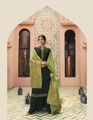 Go With Shades Of Green With This Designer Straight Cut Suit In Dark Green Colored Top And bottom Paired With Light Green Colored Dupatta. Its Pretty Embroidered Top Is Fabricated On Satin Georgette Paired With Santoon Bottom And Banarasi Art Silk Dupatta. 