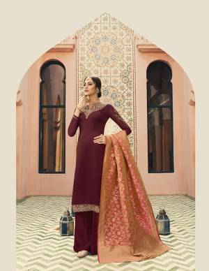 For A Royal And Elegant Look, Grab This Designer Straight Cut Suit In Maroon Color Paired With Contrasting Dark Peach Colored Dupatta. Its Embroidered Top Is Fabricated On Satin Georgette Paired With Santoon Bottom And Banarasi Art Silk Dupatta. Its Attractive Embroidery And Rich Silk Dupatta Gives The highlight To The Suit.