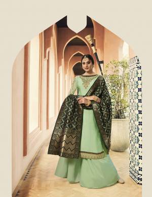 Go With Shades Of Green With This Designer Straight Cut Suit In Light Green Colored Top And bottom Paired With Dark Green Colored Dupatta. Its Pretty Embroidered Top Is Fabricated On Satin Georgette Paired With Santoon Bottom And Banarasi Art Silk Dupatta. 