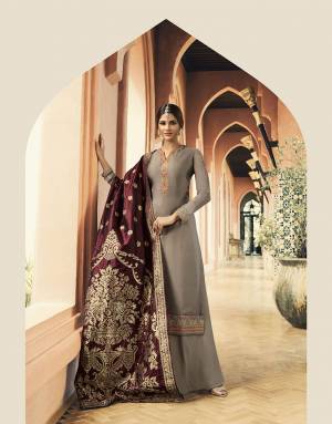 Rich And Elegant Looking Designer Straight Cut Suit Is Here In Grey Color Paired With Contrasing Maroon Colored Dupatta. Its Top Is Fabricated On Satin Georgette Paired With Santoon Bottom And Banarasi Art Silk Dupatta. All Its Fabrics Are Soft Towards Skin And Easy To Carry All Day Long. 