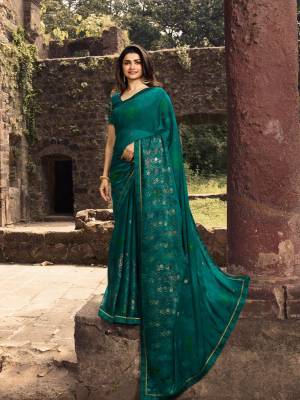 New Shade In Green Is Here With This Designer Saree In Teal Green Color Paired With Teal Green Colored Blouse. This Saree Is Georgette Based Beautified Foil Prints Paired With Jacquard And Art Silk Fabricated Blouse. Buy now.