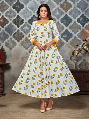 Simple And Elegant Looking Designer Readymade Kurti Is Here In White Color Fabricated On Crepe. This A-Line Kurti Is Beautified With Yellow Colored Floral Prints All Over It. 