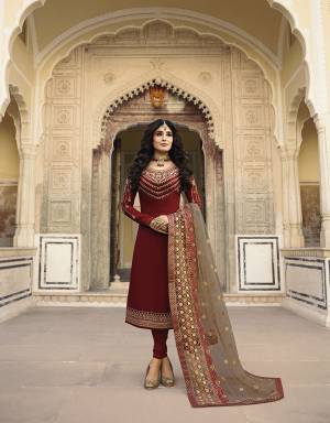 Grab This Designer Heavy Embroidered Suit Which IS Suitable For All Age Group In Maroon Colored Top And Bottom Paired With Contrasting Grey Colored Dupatta. Its Top And Dupatta Are Beautified With Heavy Embroidery. Its Top Is Fabricated On Satin Georgette Paired With Santoon Bottom And Net Fabricated Dupatta. 
