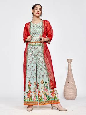 New And Unique Patterned Designer Indo-Western Pair Is Here In Aqua Blue Colored Top And Bottom Paired With A Red Colored Jacket. This Pretty Readymade Pair Is Fabricated On Muslin Beautified With Prints Paired With A Jacket Fabricated On Orgenza. 