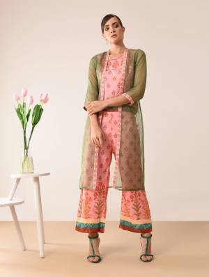 Here Is A Very Pretty Designer Indo-Western Three Piece Set. Its Top And Bottom Are In Pink Color Paired With Olive Green Colored Jacket. It Is Fabricated On Muslin Beautified With Prints All Over Paired With Orgenza Fabricated Jacket. Buy Now.