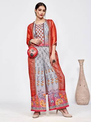New And Unique Patterned Designer Indo-Western Pair Is Here In Grey Colored Top And Bottom Paired With A Red Colored Jacket. This Pretty Readymade Pair Is Fabricated On Muslin Beautified With Prints Paired With A Jacket Fabricated On Orgenza. 