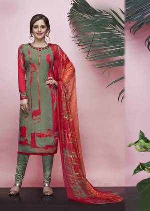 New Shade Is Here To Add Into Your Casuals With This Dress Material In Olive Green Color Paired With Contrasting Red Colored Dupatta. Its Top And Bottom are Fabricated On American Crepe Paired With Chiffon Fabricated Dupatta. 