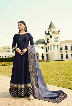 Enhance Your Personality Wearing This Attractive Designer Floor Length Suit In Navy Blue Color Paired With Contrasting Light Blue Colored Dupatta. Its Top Is Silk Based Paired With Santoon bottom And Banarasi Art Silk Dupatta. Its Rich Color And Embroidery Will Earn You Lots Of Compliments From Onlookers. 