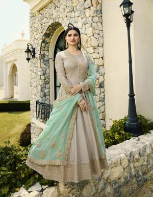 Flaunt Your Rich And Elegant Taste Wearing This Subtle Shade Color Pallete with This Heavy Designer Floor Length Suit In Grey Color Paired With Contrasting Sea Green Colored Dupatta. Its Heavy Embroidered Top Is Silk Based Paired With Santoon Bottom And Embroidered Georgette Fabricated Dupatta. Buy This Now. 
