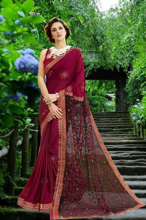 For A Royal Look, Grab This Heavy Designer Saree In Maroon Color Paired With Maroon Colored Blouse. This Saree Is Fabricated On Georgette And Net Paired With Art Silk Fabricated Blouse. Its Rich Fabric And Color Will Earn You Lots Of Compliments From Onlookers. 