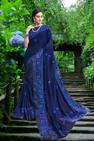 Get Ready For The Upcoming Festive Season Wearing This Saree In Bright Blue Color Paired With Blue Colored Blouse. This Saree Is Fabricated On Georgette Paired With Art Silk Fabricated Blouse. It Is Beautified with Tone To Tone Resham Embroidery With Stone Work. Buy Now.