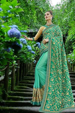 Heavy Designer Saree Is Here In Sea Green Color Paired With Beige Colored Blouse. This Saree Is Fabricated On Art Silk And Georgette paired With Art Silk Fabricated Blouse. Its Pallu Has All Over Heavy Embroidered With Jari Embroidery And Stone Work.