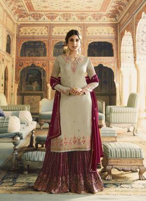 New Shade Is Here To Add Into Your Wardrobe With This Designer Sharara Suit In Sand Grey Colored Top Paired With Contrasting Magenta Pink Colored Bottom And Dupatta. Its Top Is Fabricated On Satin Georgette Paired With Georgette Fabricated Bottom And Dupatta. 