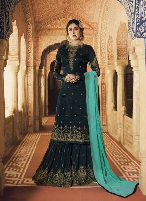 Go With The Lovely Shades Of Blue With This Designer Sharara Suit In Prussian Blue Color Paired With Turquoise Blue Colored Dupatta. Its Embroidered Top IS Satin Georgette Based Paired With Embroidered Georgette Fabricated Bottom And Dupatta. 