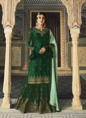 Go With The Lovely Shades Of Green With This Designer Sharara Suit In Dark Green Color Paired With Pastel Green Colored Dupatta. Its Embroidered Top IS Satin Georgette Based Paired With Embroidered Georgette Fabricated Bottom And Dupatta. 
