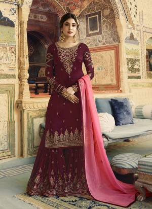 Grab This Beautiful Designer Sharara Suit In Maroon Color Paired With Contrasting Pink Coloredd Dupatta. Its Top Is Fabricated On Satin Georgette Paired With Georgette Bottom And Dupatta. All Three Piece Are Beautified With Attractive Embroidery. 