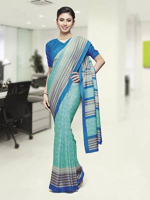 Comfort Is The First Priority When You Go To Your Work Place. So Keeping Your Comfort In Mind This Printed Saree Is Designed As A Uniform For Your Work Place. This Saree And Blouse are Fabricated On Faux Georgette Beautified With Prints Which Is Also Light In Weight And Easy To Carry All Day Long. 