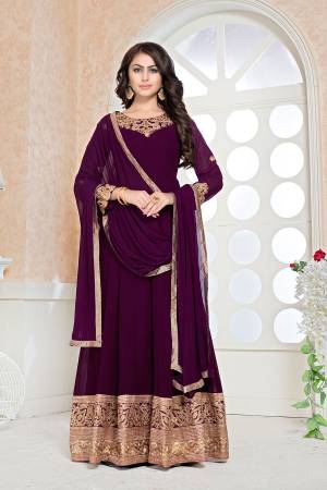 Rich And Elegant Looking Designer Floor Length Suit Is Here In Wine Color Paired With Wine Colored Bottom And Dupatta. Its Floor Length Top Is Fabricated Faux Georgette Beautified With Embroidery Over Front And And Back Paired With Santoon Bottom And Chiffon Dupatta. 