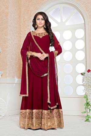 Rich And Elegant Looking Designer Floor Length Suit Is Here In Maroon Color Paired With Wine Colored Bottom And Dupatta. Its Floor Length Top Is Fabricated Faux Georgette Beautified With Embroidery Over Front And And Back Paired With Santoon Bottom And Chiffon Dupatta. 