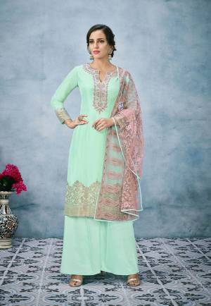 Here Are Pretty Summery Cool Shades To Add Into Your Wardrobe With This Designer Suit In Aqua Green Color Paired With Contrasting Pink Colored Dupatta. Its Top Is Fabricated On Banarasi Jacquard Silk Paired With Santoon Bottom And Net Fabricated Dupatta. The Attractive Of This Suit Is Its Heavy Lakhnavi Embroidered Dupatta. Buy Now.