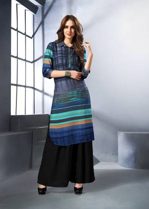 Grab This Readymade Kurti In Shades Of Blue. This Pretty Kurti Is Fabricated On Rayon Beautified With Prints All Over. Buy This Now.