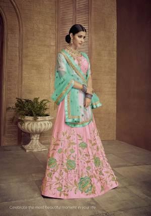Look Pretty In This Designer Pink Colored Lehenga Choli Paired With Contrasting Turquoise Blue Colored Dupatta. It Is Satin Silk Based Beautified With Attractive Embroidery Paired With Net Fabricated Dupatta. 