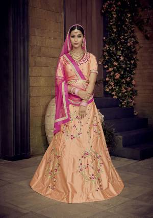 Look Pretty In This Designer Peach Colored Lehenga Choli Paired With Contrasting Rani Pink Colored Dupatta. It Is Satin Silk Based Beautified With Attractive Embroidery Paired With Net Fabricated Dupatta.  Buy Now.