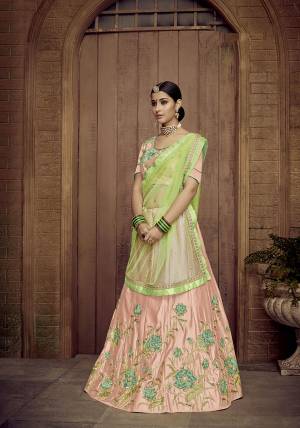 Look Pretty In This Designer Peach Colored Lehenga Choli Paired With Contrasting Light Green Colored Dupatta. It Is Satin Silk Based Beautified With Attractive Embroidery Paired With Net Fabricated Dupatta.  Buy Now.