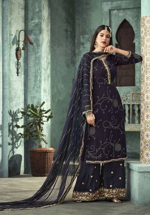 Enhance Your Personality Wearing This Designer Plazzo Suit In Navy Blue Color. Its Top Is Georgette Based Paired With Santoon Bottom And Chiffon Dupatta. It Is Beautified With Attractive Foil Prints And Embroidery. Buy Now.