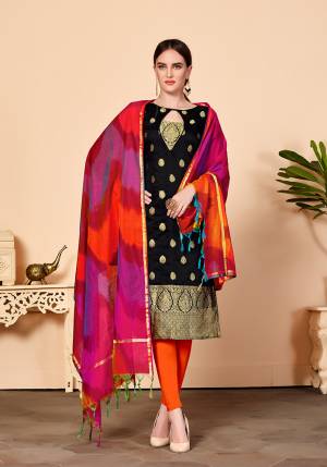 For Your Caasuals Or Semi-Casuals, Grab This Pretty Dress Material In Black Colored Top Paired With Orange Colored Bottom And Multi Colored Dupatta. Its Top Is Fabricated On Jacquard Silk Paired With Cotton Fabricated Bottom And Banarasi Art Silk Dupatta. Buy Now.