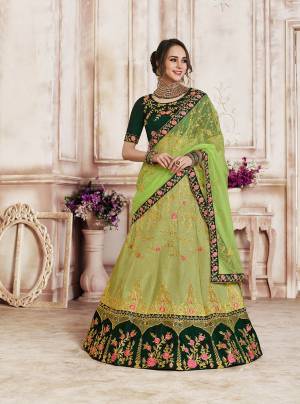 Go With The Shades Of Fresh Green Colors With This Heavy Designer Lehenga Choli In Dark Green Colored Blouse Paired With Light Green Colored Bottom And Dupatta. Its Blouse And Lehenga Are Fabricated On Art Silk Paired With Net Fabricated Dupatta. 